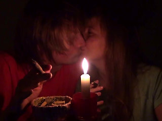 Couple smoke next to candle