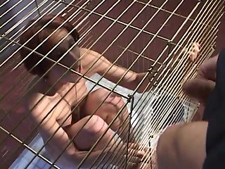Submissive slut blowing police officers dick while in cage
