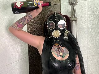 Dominatrix Nika In A Gas Mask Pours Wine Over Her Latex Body. Latex Fetish