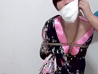 Layers of gag on bound Chinese girl