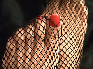 Tiny feet in fishnet stocking...red toe nails