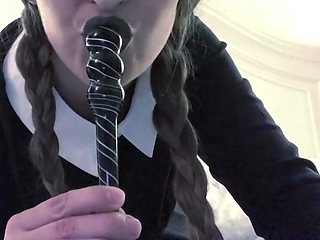 Braided blonde in dark-hued dress roleplay on a bed