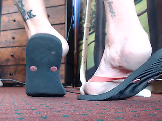 Very worn black flipflops