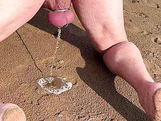 Piss in a chastity cage outdoors in front of his wife