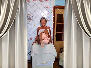 Cheerful housewife Lukerya in the kitchen