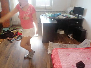 Amateur woman has fun trying on clothes and cutting them.