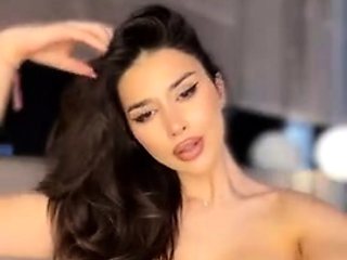Busty babe playing with her big boobs