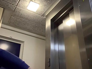 In the hall in front of the elevator