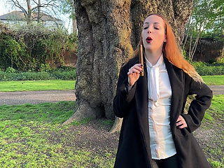 Liz Rainbow Smoking a Flor De Oliva Cigar Outdoors