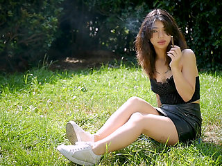 Arina Is Smoking One Black Cigarette Outdoors