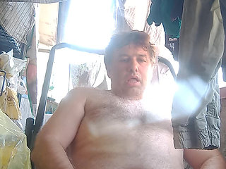 Guy jerks off on the deckchair cumming and evaluating his cum