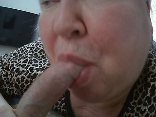 a fat woman makes a deep blowjob sucks balls and looks at a cumming dick