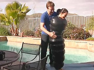Julia in an inflatable latex cocoon in pool