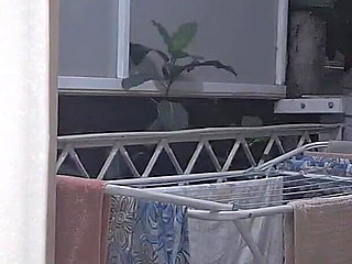 Naughty Housewife Showing off to Passers-by While Her Husband Works