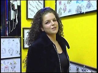 Fabulous brunette with curly hair wants a new tattoo