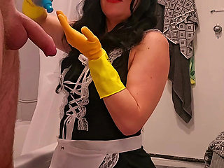 Chubby Milf Maid Bound Ember, gives handjob to hotel guest in rubber gloves then takes a cumshot facial