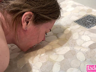 Submissive slut drinking piss from bathroom floor after sex