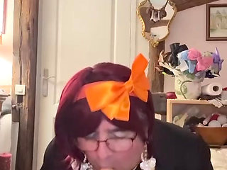 In an outfit with a little white skirt to suck a dildo