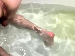 athletic guy fucks his ass with dildo in bathtub