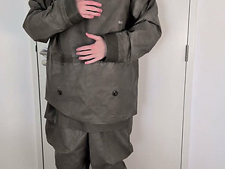 Putting on Zodiac Zodiak heavy rubber hazmat suit over plastic pants and gas mask