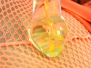 Glass Dildo Solo in an Orange Fishnet Bodysuit - Busty Brunette Plays on the Couch
