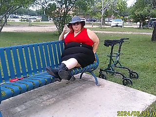 Nurse Vicki Smoking in the Park on a Bench All Dressed up
