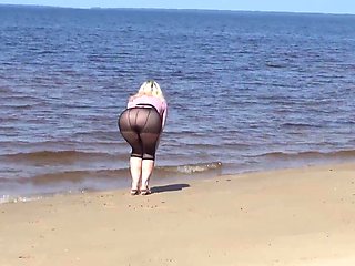 Jokey cougar with nylon caboose and breasts on beach