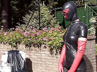 Leather woman gets dominated outdoor