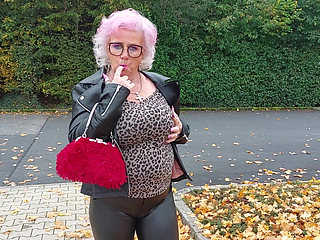 Naughty Granny Tongue Out Flashing Big Tits in Public