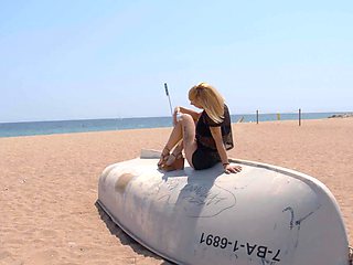 The sexy blonde Perla Rubia on the beach in a fishnet outfit