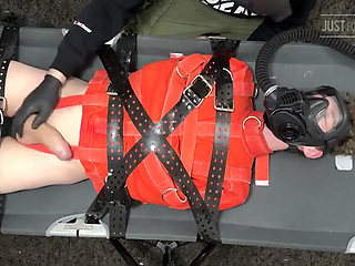 Bondage Twink Strapped to Campbed in Straitjacket and Gas Mask