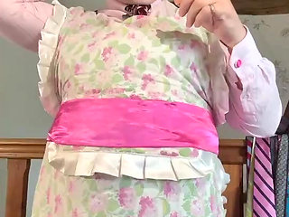 Dressed as a maid to put on a gag and a mask for some sewing