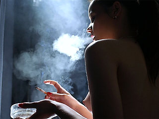 Young Brunette Smoking in Red Tulle Skirt