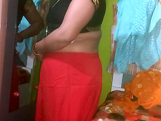 Indian housewife is wearing a yellow saree.