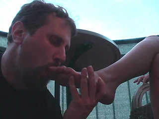 Sexy femdom smoking a cigarette while getting feet licked and toes sucked