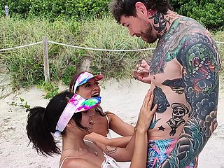 Four sexy people have a great fun on the beach with dan