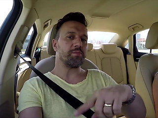 First hands on the steering wheel then mouth on the cock