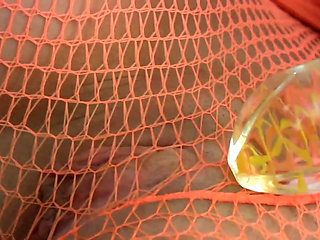 Babe in fishnet outfit rips pantyhose and puts a dildo in her shaved cunt