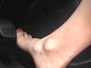 Nyllady with Her Bare Foot on Gas Pedal Driving