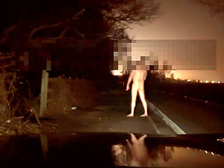 Crazy naked exhibition barefoot with cars passing close