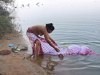 Indian village wife bathing in the river in outdoor area