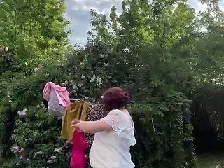 Dressed in a white lace dress to hang the laundry
