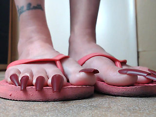 Long red toenails pink flipflops