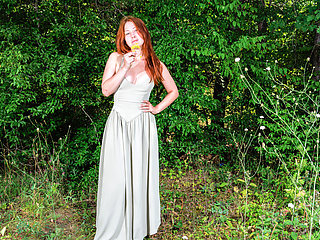 Pale redhead with perfect curves is naked in nature