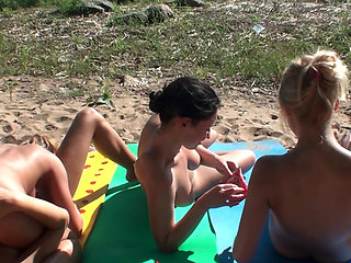 Four Tanned Stepsisters Lick Their Pussies in the Sun on the Beach