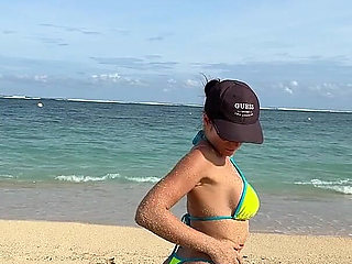 Teasing on the Beach in Micro Bikini on the Sand