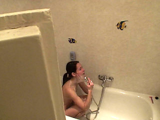 Sexy brunette teen is taking a shower