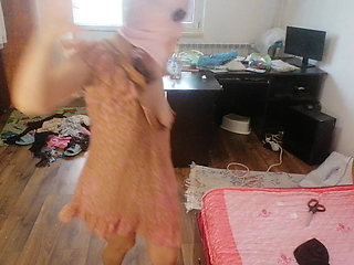 Amateur woman has fun trying on clothes and cutting them.