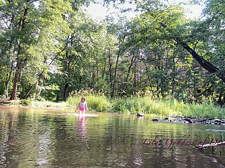 Cute Teen in Costume Playing in the River Like in a Swimming Pool
