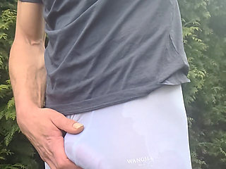 Skinny boy in white Wet Leggings shows his big bulge in public. Risky outdoor wanking his big cock